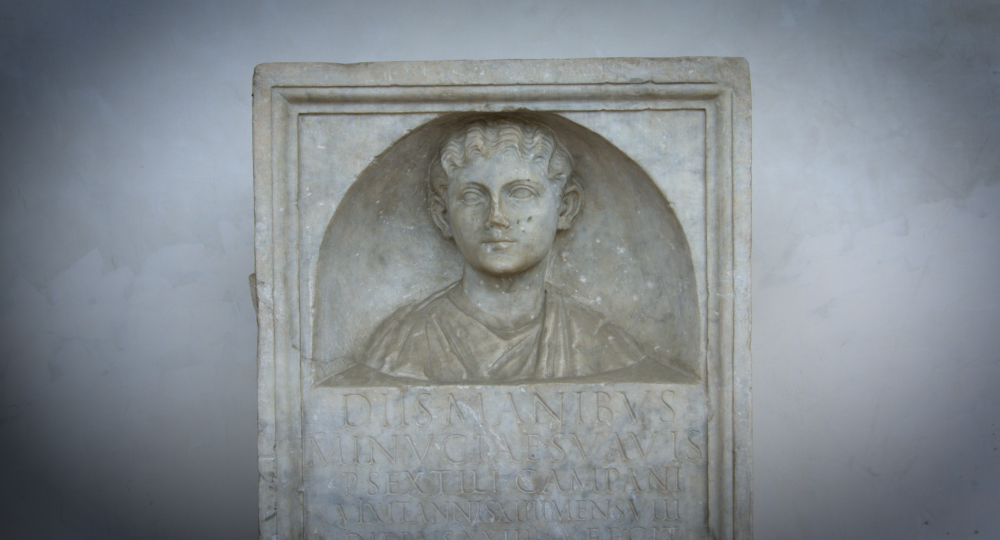 Relief of a woman's head and shoulders above an inscription