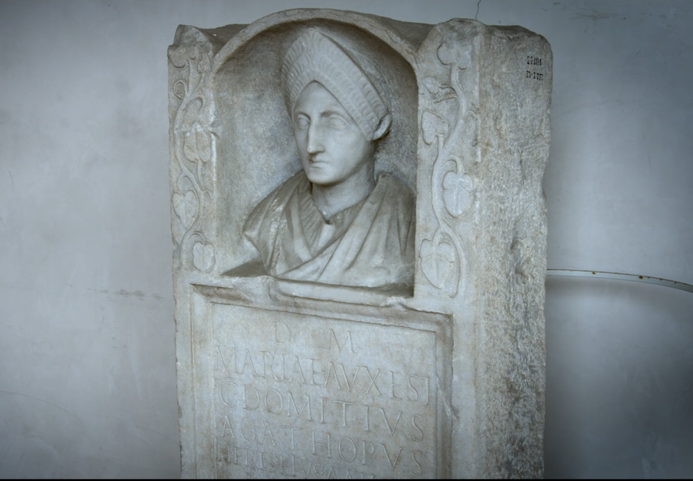 Marble monument with portrait bust of a woman above an inscription