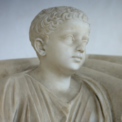statue of a boy with a fig
